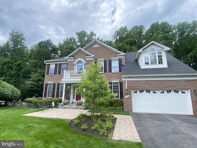 2240 Ballard Way, Ellicott City, MD 21042 - colonial-style house with brick siding, driveway, a front lawn, and a balcony
