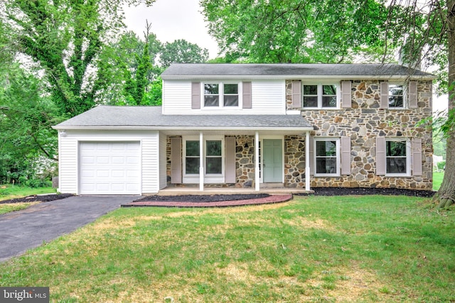 406 Christian Ln, Wallingford, PA 19086 - traditional home featuring stone siding, driveway, covered porch, an attached garage, and a front lawn