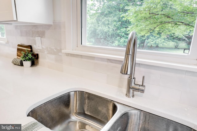 406 Christian Ln, Wallingford, PA 19086 - kitchen view of decorative backsplash, white cabinets, and light countertops