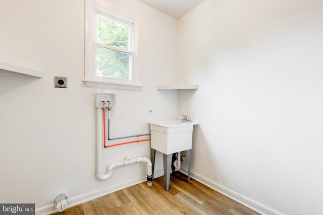 406 Christian Ln, Wallingford, PA 19086 - laundry room with gas dryer hookup, hookup for a washing machine, light wood finished floors, and electric dryer hookup