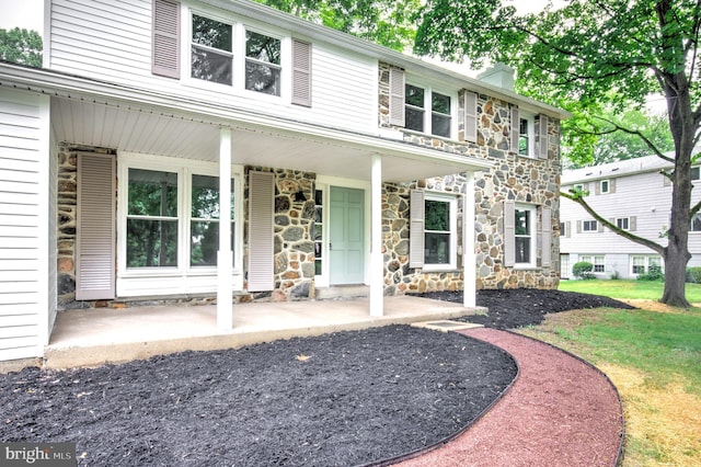 406 Christian Ln, Wallingford, PA 19086 - view of front of property featuring stone siding, a chimney, and a porch