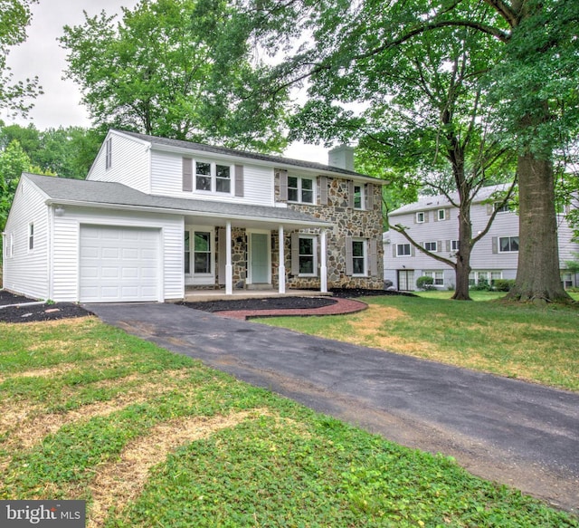 406 Christian Ln, Wallingford, PA 19086 - view of front of property featuring an attached garage, a chimney, driveway, stone siding, and a porch