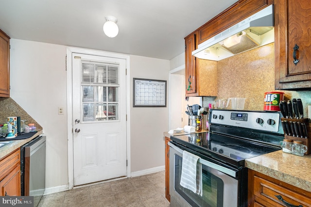 313 E Main St, Mechanicsburg, PA 17055 - kitchen featuring appliances with stainless steel finishes, under cabinet range hood, brown cabinets, and tasteful backsplash