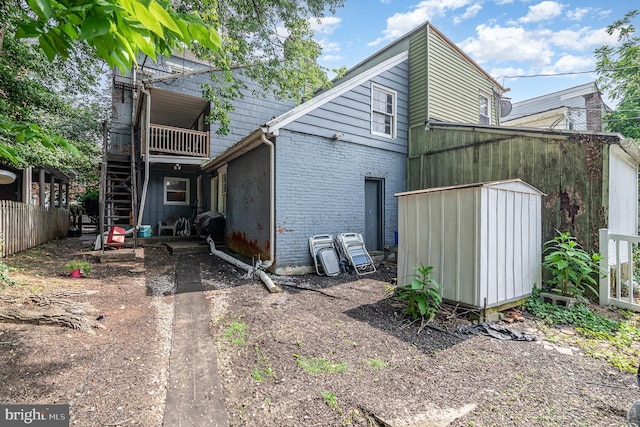 313 E Main St, Mechanicsburg, PA 17055 - back of house featuring stairway, a storage shed, and brick siding
