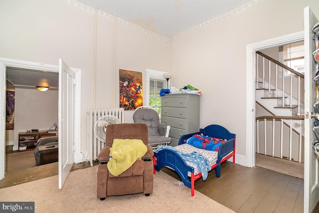 313 E Main St, Mechanicsburg, PA 17055 - living area featuring radiator heating unit, stairway, and wood finished floors