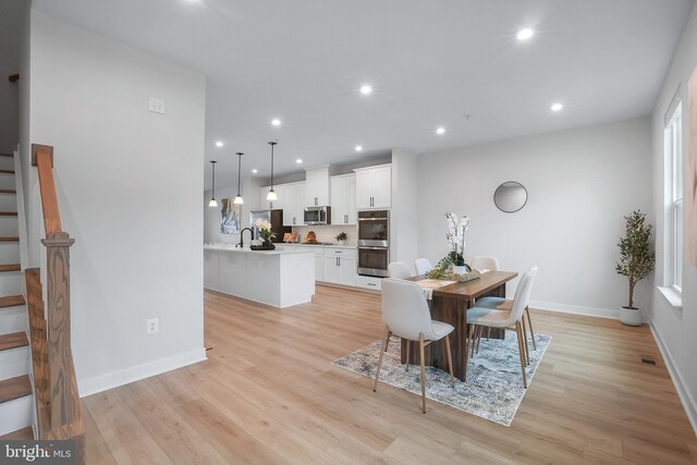 8109 Primrose Ln, Laurel, MD 20723 - dining area featuring stairs, light wood-type flooring, and recessed lighting