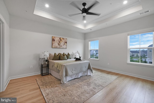 8109 Primrose Ln, Laurel, MD 20723 - bedroom featuring a tray ceiling, light wood-type flooring, recessed lighting, ornamental molding, and a ceiling fan