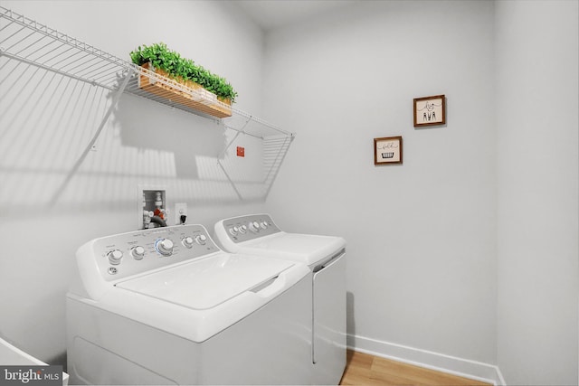 8109 Primrose Ln, Laurel, MD 20723 - washroom with washer and dryer and wood finished floors