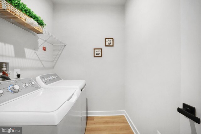 8109 Primrose Ln, Laurel, MD 20723 - washroom featuring washing machine and clothes dryer and light wood-style flooring