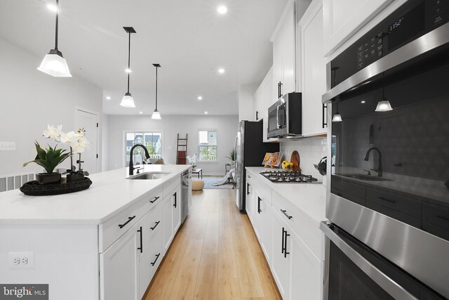 8109 Primrose Ln, Laurel, MD 20723 - kitchen featuring appliances with stainless steel finishes, light wood finished floors, recessed lighting, light countertops, and white cabinets