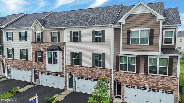 8109 Primrose Ln, Laurel, MD 20723 - multi unit property featuring driveway, stone siding, and an attached garage