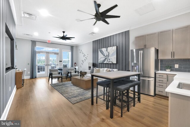 8109 Primrose Ln, Laurel, MD 20723 - dining space with ceiling fan, crown molding, light wood-type flooring, french doors, and recessed lighting