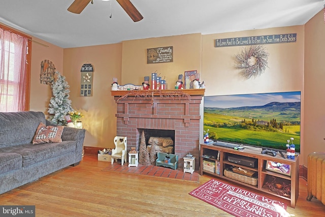 439 Columbia St, Cumberland, MD 21502 - living area featuring wood finished floors, a ceiling fan, and a brick fireplace