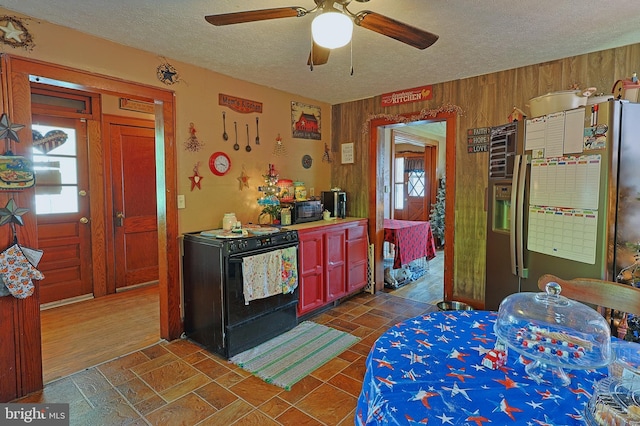 439 Columbia St, Cumberland, MD 21502 - kitchen with stainless steel fridge, range with gas stovetop, a textured ceiling, healthy amount of natural light, and ceiling fan