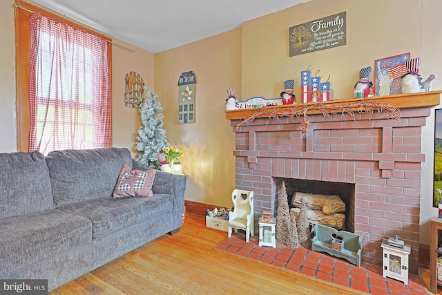 439 Columbia St, Cumberland, MD 21502 - living room featuring wood finished floors and a brick fireplace