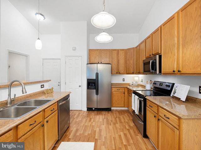 207 Drawyers Dr, Middletown, DE 19709 - kitchen with appliances with stainless steel finishes, decorative light fixtures, light wood-style flooring, light countertops, and a high ceiling
