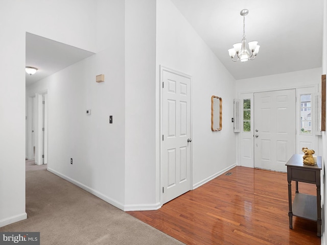 207 Drawyers Dr, Middletown, DE 19709 - entryway featuring a chandelier, high vaulted ceiling, and wood finished floors