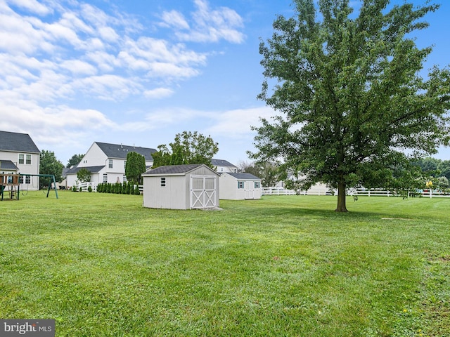 207 Drawyers Dr, Middletown, DE 19709 - view of green lawn with a storage shed and a playground