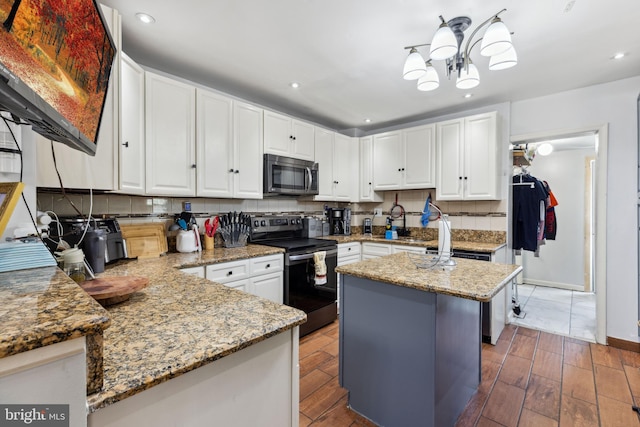 5509 Chew Ave, Philadelphia, PA 19138 - kitchen with stainless steel appliances, backsplash, white cabinetry, and recessed lighting