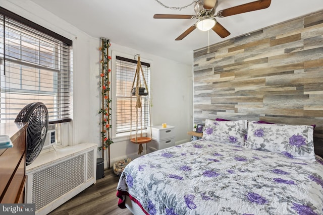 5509 Chew Ave, Philadelphia, PA 19138 - bedroom featuring radiator, wood finished floors, an accent wall, wood walls, and ceiling fan