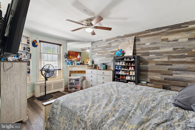 5509 Chew Ave, Philadelphia, PA 19138 - bedroom featuring radiator, dark wood-type flooring, wooden walls, and an accent wall