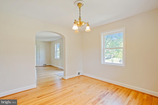 5909 Frederick St, Springfield, VA 22150 - unfurnished room featuring arched walkways, wood finished floors, and a chandelier