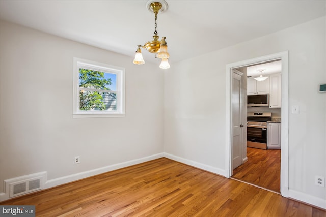 5909 Frederick St, Springfield, VA 22150 - empty room with light wood-type flooring and a chandelier