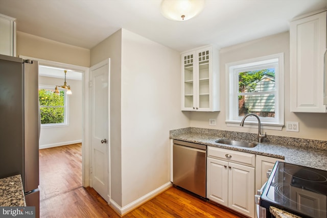 5909 Frederick St, Springfield, VA 22150 - kitchen with appliances with stainless steel finishes, wood finished floors, glass insert cabinets, and white cabinets