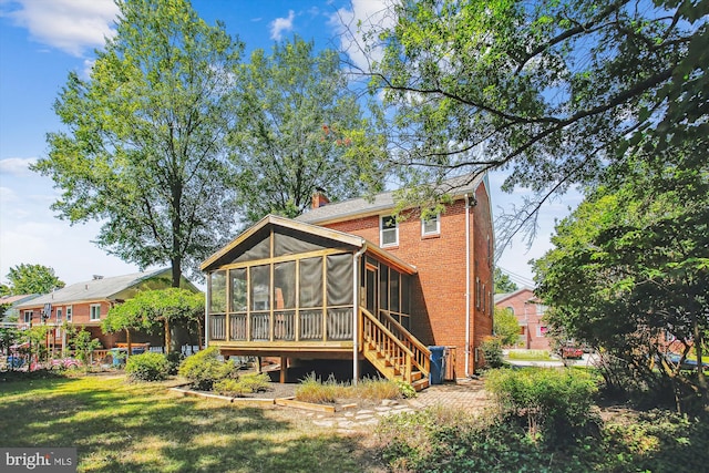5909 Frederick St, Springfield, VA 22150 - rear view of property featuring a sunroom, brick siding, and a lawn