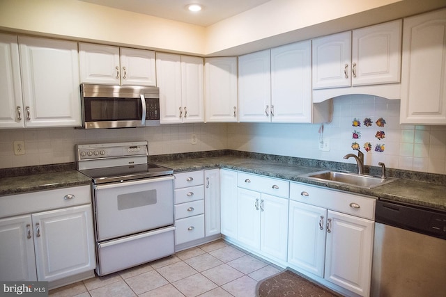16 Stonehenge Cir Unit 16-5, Baltimore, MD 21208 - kitchen featuring appliances with stainless steel finishes, dark countertops, and white cabinetry