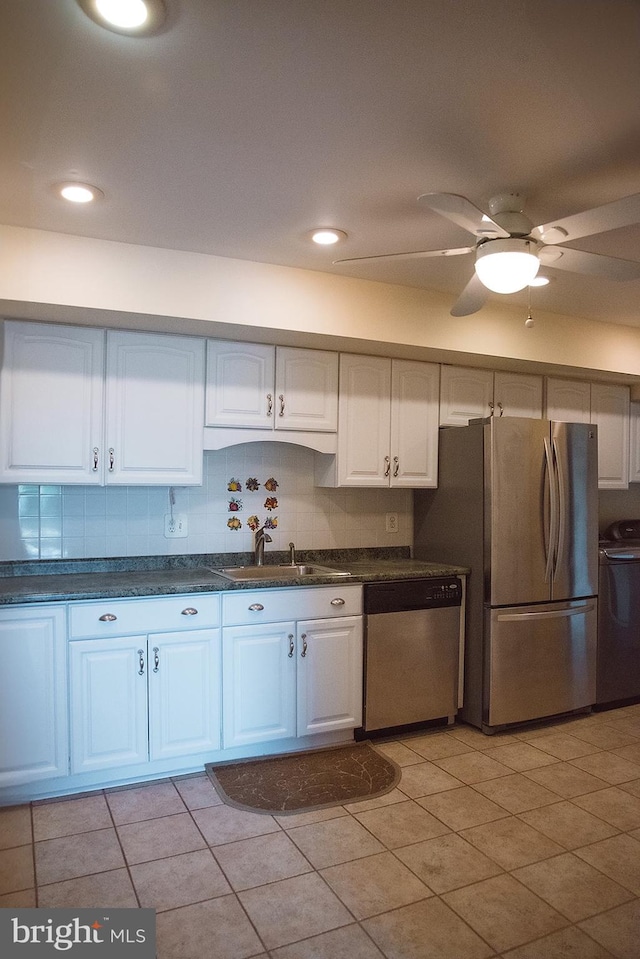 16 Stonehenge Cir Unit 16-5, Baltimore, MD 21208 - kitchen with stainless steel appliances, dark countertops, white cabinetry, washing machine and clothes dryer, and light tile patterned floors