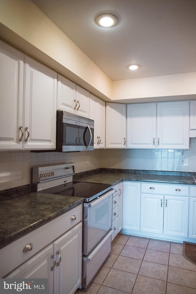 16 Stonehenge Cir Unit 16-5, Baltimore, MD 21208 - kitchen featuring white electric range, stainless steel microwave, white cabinets, and dark countertops