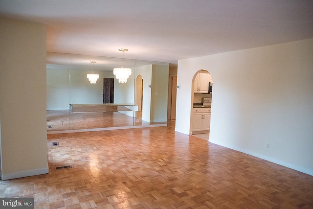 16 Stonehenge Cir Unit 16-5, Baltimore, MD 21208 - unfurnished room featuring arched walkways and a chandelier