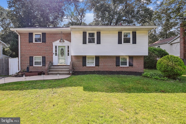 14 Nicholson Dr, Pasadena, MD 21122 - raised ranch with entry steps, brick siding, and a patio