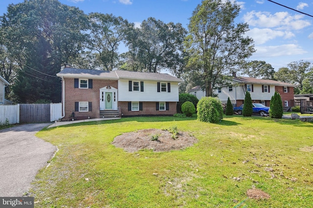 14 Nicholson Dr, Pasadena, MD 21122 - split foyer home with brick siding, entry steps, driveway, and a chimney