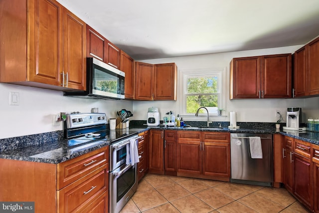 14 Nicholson Dr, Pasadena, MD 21122 - kitchen with stainless steel appliances, light tile patterned floors, and dark stone counters