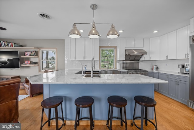 1 Risner Ave, Penns Grove, NJ 08069 - kitchen with under cabinet range hood, open floor plan, tasteful backsplash, light stone counters, and recessed lighting