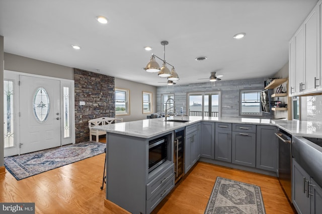 1 Risner Ave, Penns Grove, NJ 08069 - kitchen with gray cabinets, appliances with stainless steel finishes, light stone countertops, white cabinets, and a ceiling fan