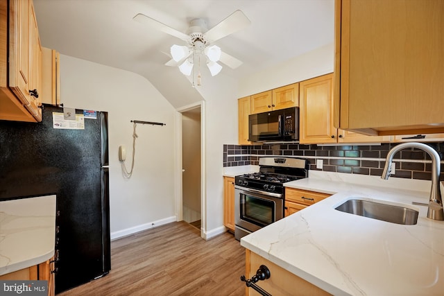 2013 Dayton St, Silver Spring, MD 20902 - kitchen with black appliances, light wood-type flooring, tasteful backsplash, light stone countertops, and vaulted ceiling