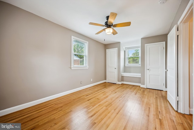 2013 Dayton St, Silver Spring, MD 20902 - unfurnished bedroom featuring multiple windows, light wood-style floors, and ceiling fan