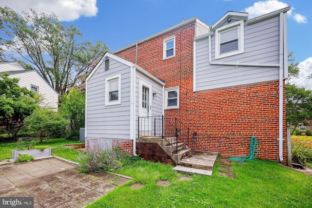 2013 Dayton St, Silver Spring, MD 20902 - rear view of house with a lawn, brick siding, and a patio