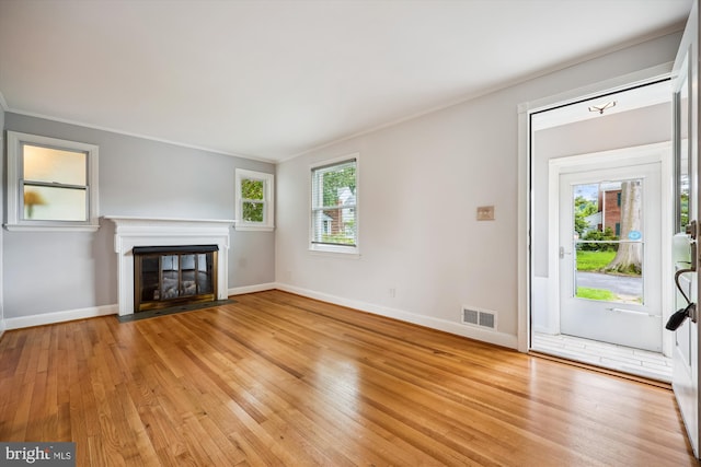2013 Dayton St, Silver Spring, MD 20902 - unfurnished living room with light wood-style floors, a fireplace with flush hearth, and ornamental molding