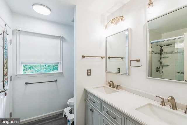 1016 Wiltshire Dr, La Plata, MD 20646 - full bath featuring double vanity, tiled shower, and wood finished floors