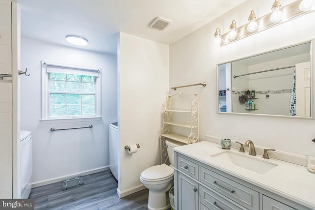 1016 Wiltshire Dr, La Plata, MD 20646 - bathroom with wood finished floors, vanity, washer / dryer, and a shower