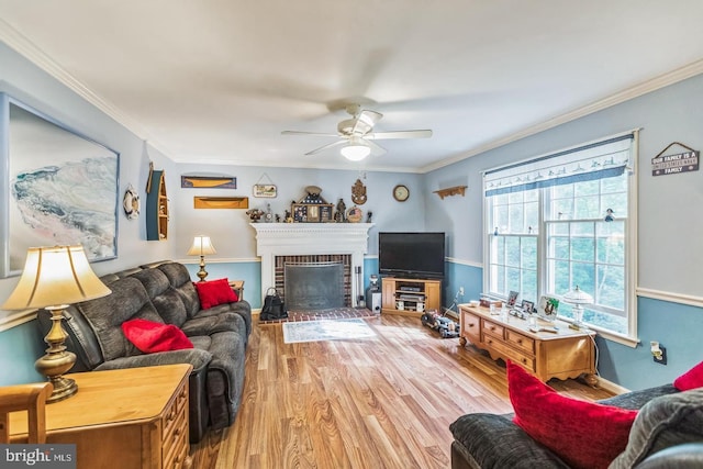 1016 Wiltshire Dr, La Plata, MD 20646 - living room featuring a ceiling fan, wood finished floors, a fireplace, and crown molding