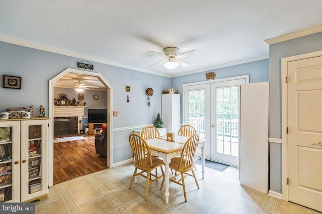 1016 Wiltshire Dr, La Plata, MD 20646 - dining space with ceiling fan, a brick fireplace, crown molding, arched walkways, and wine cooler