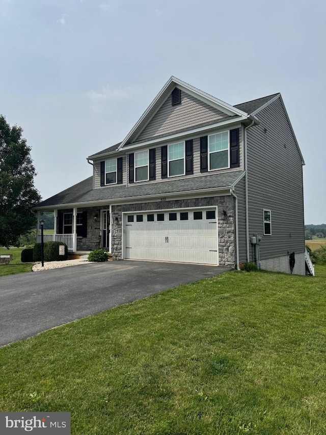 635 Queensbury Dr, Chambersburg, PA 17202 - view of front of property featuring driveway, an attached garage, a front lawn, stone siding, and covered porch