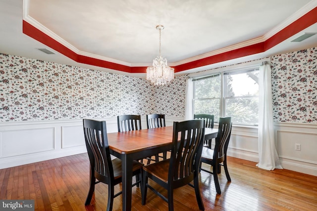 2912 Weaver Rd, Lancaster, PA 17601 - dining space featuring wallpapered walls, a chandelier, wood-type flooring, a wainscoted wall, and ornamental molding