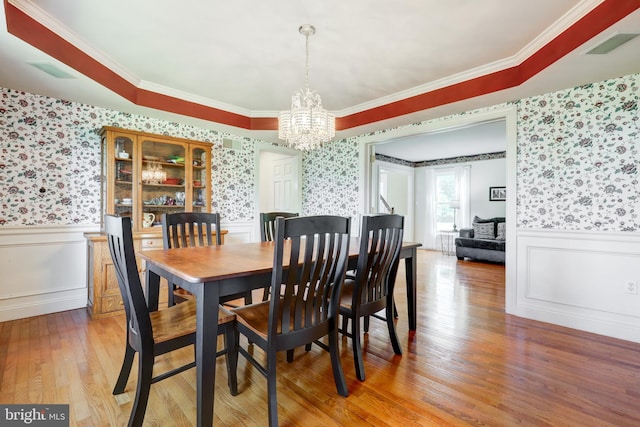 2912 Weaver Rd, Lancaster, PA 17601 - dining space featuring wallpapered walls, a chandelier, a wainscoted wall, light wood-type flooring, and ornamental molding