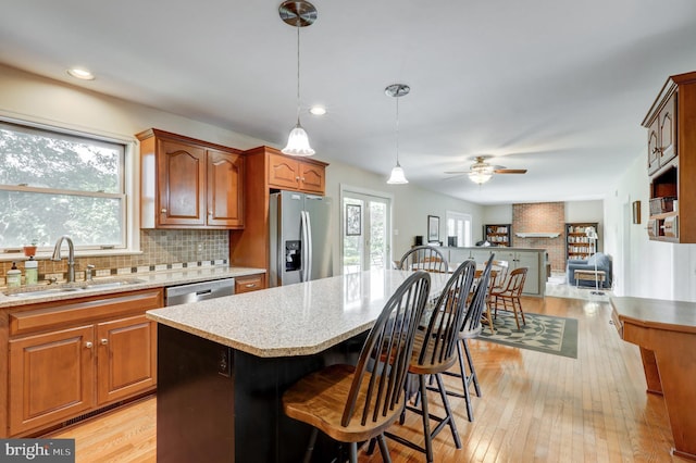 2912 Weaver Rd, Lancaster, PA 17601 - kitchen with stainless steel refrigerator with ice dispenser, a kitchen bar, decorative backsplash, light wood-style flooring, and recessed lighting